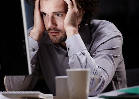 stressed looking people - Stressed young man, working late Stock Photo - Premium Royalty-Free, Code: 614-05955718