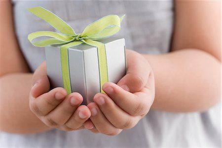 Girl holding a small gift Stock Photo - Premium Royalty-Free, Code: 614-05955794