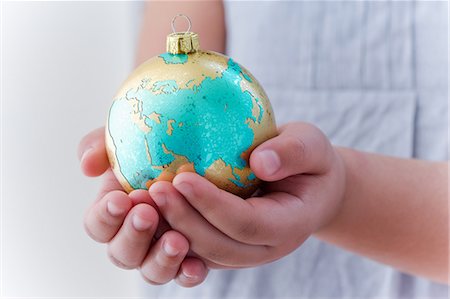 safe world - Girl holding globe decoration Stock Photo - Premium Royalty-Free, Code: 614-05955803