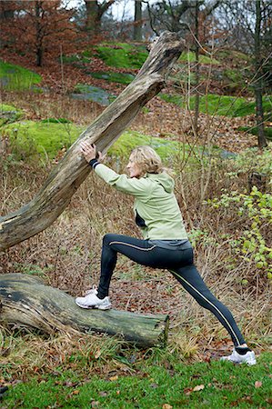 forties and one person and full length - Mature woman stretching against tree in forest Stock Photo - Premium Royalty-Free, Code: 614-06002109