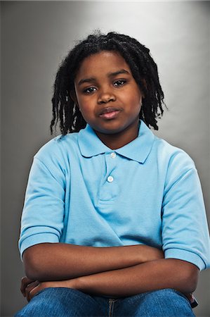 Portrait of black teenage boy, studio shot Stock Photo - Premium Royalty-Free, Code: 614-06002215