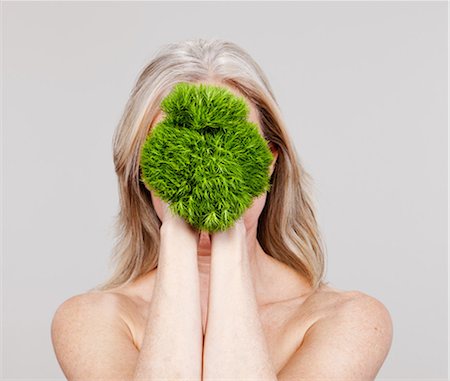 equality human - Mature woman holding plant in front of face Stock Photo - Premium Royalty-Free, Code: 614-06002262