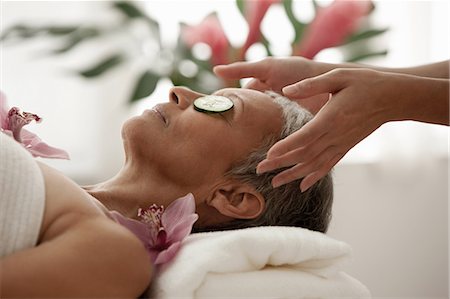 spa tranquility - Senior woman wearing cucumber slices and relaxing on massage table Stock Photo - Premium Royalty-Free, Code: 614-06002273