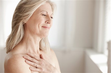 equality human - Mature woman touching neck Stock Photo - Premium Royalty-Free, Code: 614-06002283