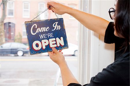 sign (instructional only) - Man flipping over open sign in cafe Stock Photo - Premium Royalty-Free, Code: 614-06002318
