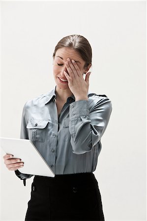 stressed looking people - Young businesswoman using digital tablet, studio shot Stock Photo - Premium Royalty-Free, Code: 614-06002366