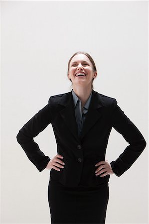 portraits color background - Young businesswoman laughing, studio shot Stock Photo - Premium Royalty-Free, Code: 614-06002368