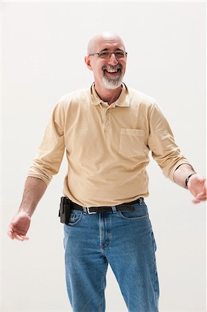 Mature man smiling, studio shot Stock Photo - Premium Royalty-Free, Code: 614-06002402