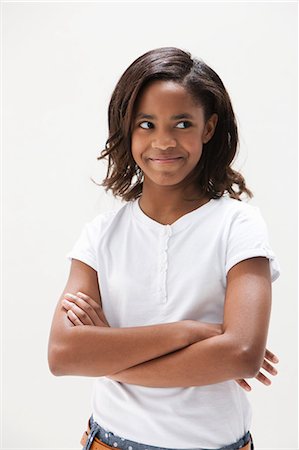 portrait expressions - African American girl looking away, studio shot Stock Photo - Premium Royalty-Free, Code: 614-06002411