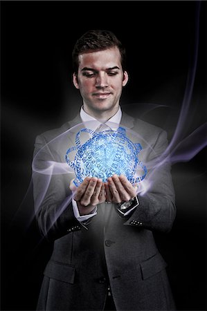 people holding globe - Man holding holographic information ball Stock Photo - Premium Royalty-Free, Code: 614-06044001