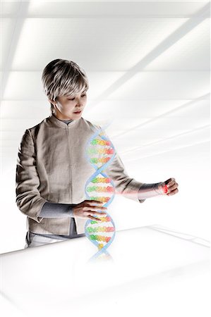 Female scientist interacting with holographic genome Stock Photo - Premium Royalty-Free, Code: 614-06044025