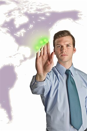 earth future - Businessman interacting with holographic map Stock Photo - Premium Royalty-Free, Code: 614-06044023