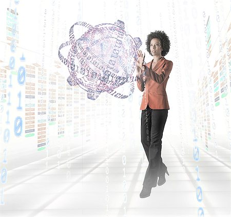 Businesswoman standing amidst digital objects Stock Photo - Premium Royalty-Free, Code: 614-06044035