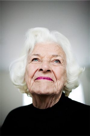Portrait of senior woman looking up, studio shot Stock Photo - Premium Royalty-Free, Code: 614-06044108