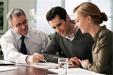 Financial advisor meeting with young couple Stock Photo - Premium Royalty-Free, Code: 614-06044368