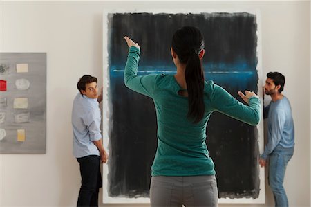 Art dealer arranging hanging of oil painting in gallery Stock Photo - Premium Royalty-Free, Code: 614-06044496