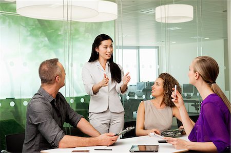 Office colleagues discussing new technologies on desk Stock Photo - Premium Royalty-Free, Code: 614-06044507