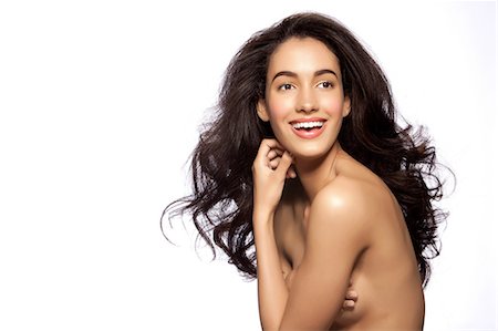 Young naked woman smiling against white background Stock Photo - Premium Royalty-Free, Code: 614-06044673