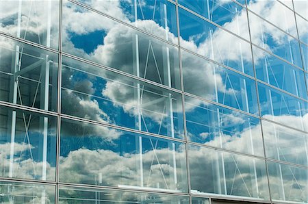 reflection in glass - Cloudy blue sky reflected in office windows Stock Photo - Premium Royalty-Free, Code: 614-06044730