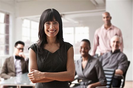 filipino ethnicity male - Portrait of businesswoman with colleagues in background Stock Photo - Premium Royalty-Free, Code: 614-06043777