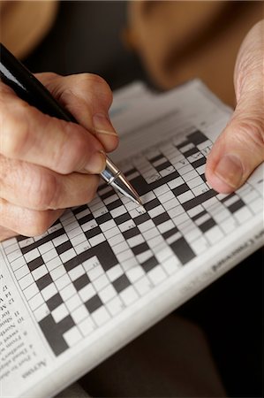 senior woman newspaper - Senior woman doing crossword Stock Photo - Premium Royalty-Free, Code: 614-06043847