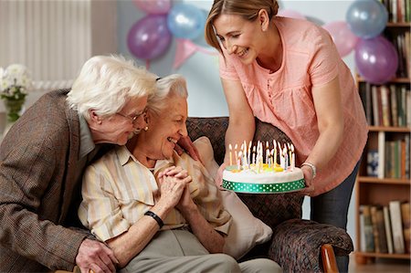 Daughter giving birthday cake to senior mother Stock Photo - Premium Royalty-Free, Code: 614-06043865