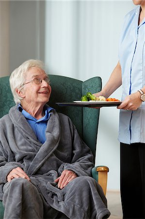 senior care nursing home - Carer bringing meal to senior man Stock Photo - Premium Royalty-Free, Code: 614-06043880