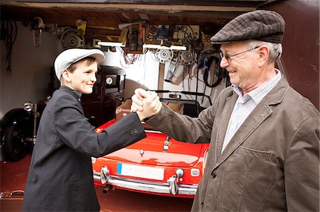 Grandfather and grandson shaking hands Stock Photo - Premium Royalty-Free, Code: 614-06116052