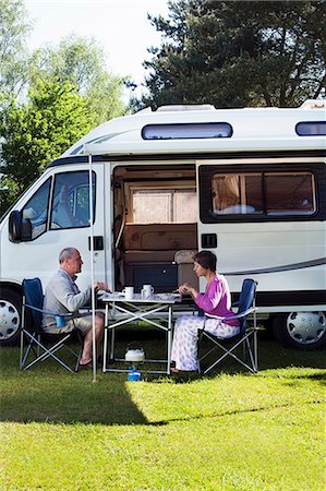 senior couple rv - Couple eating breakfast outside campervan Stock Photo - Premium Royalty-Free, Code: 614-06116109