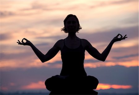 simsearch:6122-07694180,k - Silhouette of woman in lotus position at sunset Stock Photo - Premium Royalty-Free, Code: 614-06116384