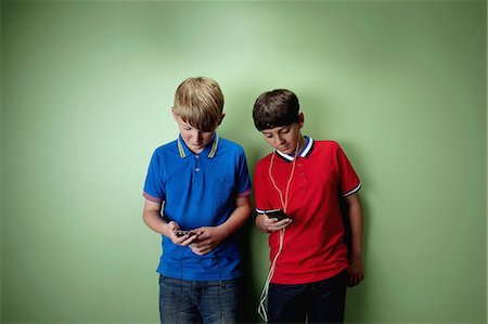 Two boys with mp3 players Stock Photo - Premium Royalty-Free, Code: 614-06116437