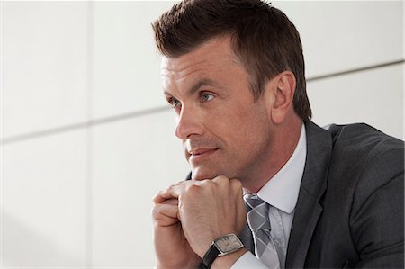 portrait business person close thinking not looking at camera - Businessman with hand on chin, portrait Stock Photo - Premium Royalty-Free, Code: 614-06116470