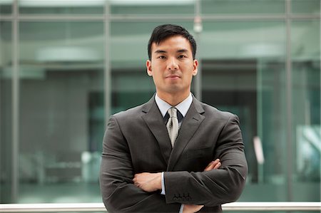 Young businessman looking at camera, portrait Stock Photo - Premium Royalty-Free, Code: 614-06116483