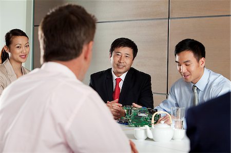 simsearch:614-06116477,k - Businesspeople discussing circuit board in meeting Stock Photo - Premium Royalty-Free, Code: 614-06116492