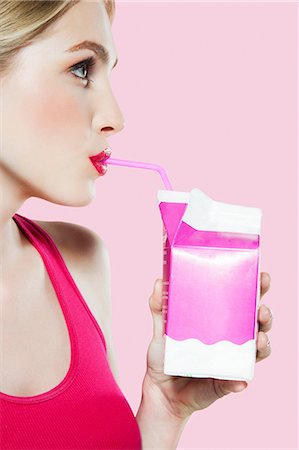 female profile face - Young woman drinking carton of milk through straw Stock Photo - Premium Royalty-Free, Code: 614-06168639