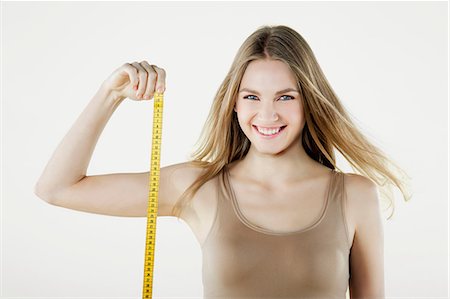 Young woman holding tape measure Foto de stock - Sin royalties Premium, Código: 614-06168644