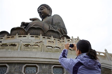 Woman taking photograph of tian tan buddha, hong kong, china Stock Photo - Premium Royalty-Free, Code: 614-06168779