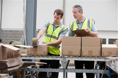 stock - Men packing cardboard box in warehouse Stock Photo - Premium Royalty-Free, Code: 614-06168857