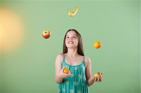 Girl juggling fruit Fotografie stock - Premium Royalty-Free, Codice: 614-06168893