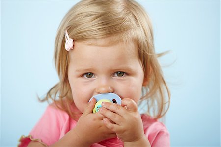 Girl with pacifier in mouth Stock Photo - Premium Royalty-Free, Code: 614-06168906
