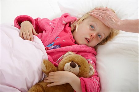 sick kid bed - Parent touching girl's forehead Stock Photo - Premium Royalty-Free, Code: 614-06168901