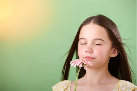 Girl sniffing flower Fotografie stock - Premium Royalty-Free, Codice: 614-06168913