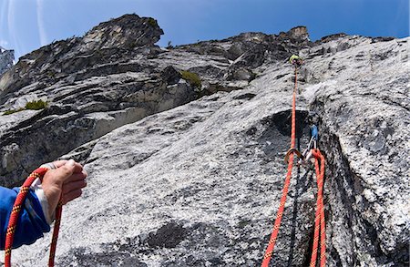 Climber belaying rock wall, Mount Berge, Cascade Range, Washington, USA Stock Photo - Premium Royalty-Free, Code: 614-06169042