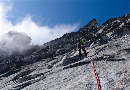 Climber rappelling rock wall, Mount Berge, Cascade Range, Washington, USA Stock Photo - Premium Royalty-Free, Code: 614-06169043
