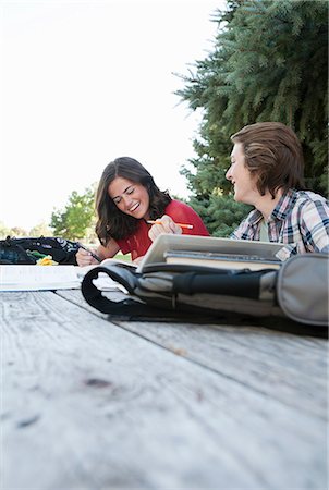 picnic table photography - Teenage couple studying at picnic table in park Stock Photo - Premium Royalty-Free, Code: 614-06169076