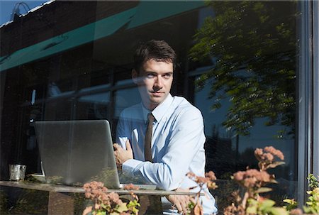 Businessman in cafe, view through window Stock Photo - Premium Royalty-Free, Code: 614-06169071