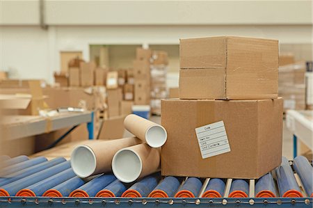 Cardboard boxes and tubes on conveyor belt Stock Photo - Premium Royalty-Free, Code: 614-06169135