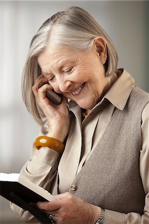 senior on the telephone - Senior woman holding picture frame on the phone Stock Photo - Premium Royalty-Free, Code: 614-06169249
