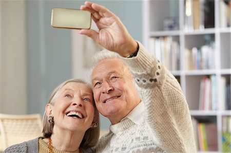 selfie cell phone indoor - Senior couple using camera phone Stock Photo - Premium Royalty-Free, Code: 614-06169279