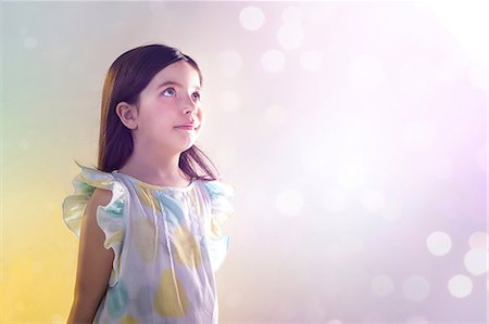 Girl looking up at lights Stock Photo - Premium Royalty-Free, Code: 614-06169337